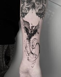 a person's hand with a tattoo on it and a bird in the middle