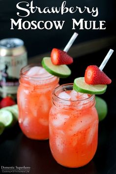 strawberry moscow mules with lime slices and strawberries on the rim, in mason jars