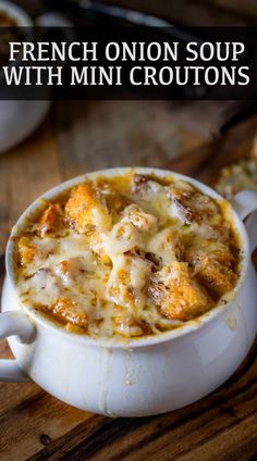 french onion soup with mini croutons in a white bowl on a wooden table