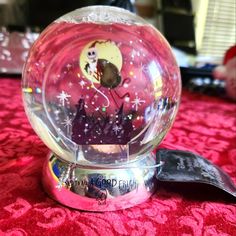 a snow globe sitting on top of a red table