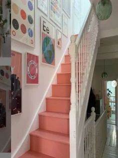 there is a staircase with pink steps and pictures on the wall above it in this house