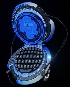 an electronic device with headphones on it is lit up in the dark and blue