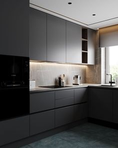 a kitchen with grey cabinets and black counter tops, along with a window that looks out onto the outdoors