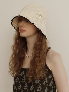 a woman wearing a white crochet hat