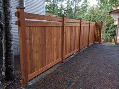 a wooden fence in front of a house