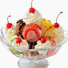 an ice cream sundae with cherries, bananas and strawberries in a glass bowl