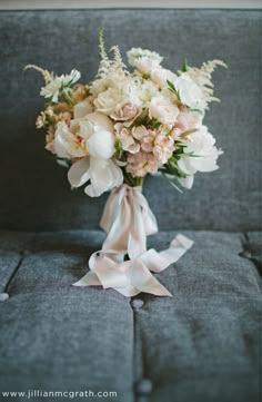 a bouquet of flowers sitting on top of a couch next to an instagram page