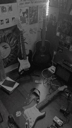 black and white photograph of guitars in room