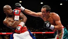 two professional boxing players in action on the ring