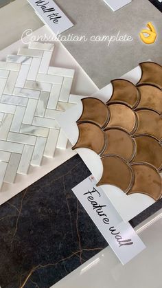 there are many different types of tiles on the counter top, including one that is brown and white