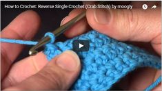 someone is crocheting the stitchs together to make a small piece of blue yarn