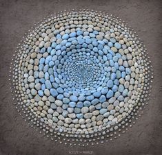 a blue and white circle made out of rocks