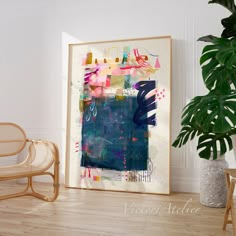 an abstract painting on the wall next to a chair and potted plant