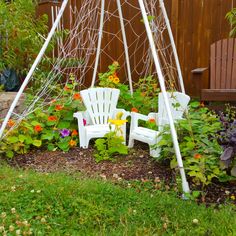 a white chair sitting in the middle of a garden