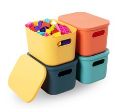 three plastic storage containers with legos in them