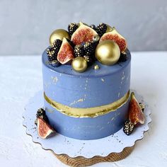 a blue cake with figurines and gold decorations