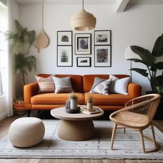 a living room with orange couches and pictures on the wall above them, along with potted plants