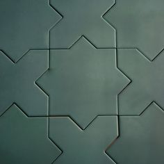 an abstract tile design in green and grey colors with star shapes on the bottom right corner