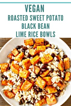 a white bowl filled with rice, beans and sweet potato salad on top of a wooden table