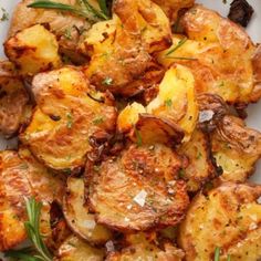 roasted potatoes with herbs and seasoning on a white plate