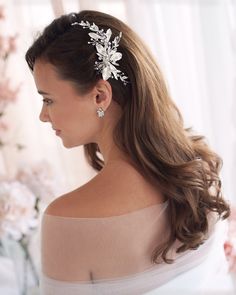 a woman wearing a hair comb with flowers on it