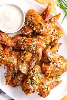 A plate of crispy garlic Parmesan wings garnished with Parmesan and herbs, served with a side of creamy dipping sauce. Crispy Air Fryer Chicken Wings, All The Healthy Things, Crispy Air Fryer Chicken, Parmesan Wings, Garlic Parmesan Wings, Parmesan Chicken Wings, Garlic Parmesan Chicken Wings, Vegan Paleo Recipes, Air Fryer Chicken Wings