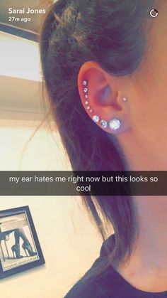 a woman with ear piercings in between her ears