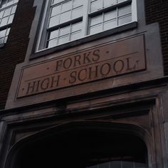 the entrance to forks high school in front of an old brick building with large windows