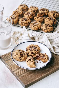 chocolate chip cookies on a plate next to a glass of milk