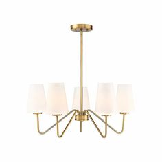 a brass chandelier with five white shades