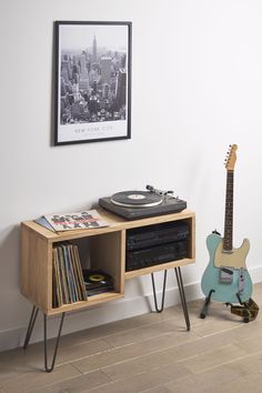 a record player is sitting next to an entertainment center