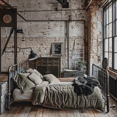 an industrial bedroom with exposed brick walls and wooden floors