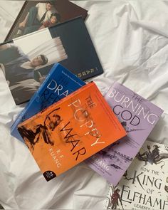 there are four books on the bed together