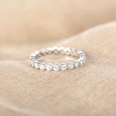 a diamond ring on top of a beige cloth