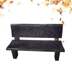 a black park bench with fall leaves in the background