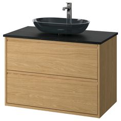 a bathroom vanity with a bowl sink and black counter top