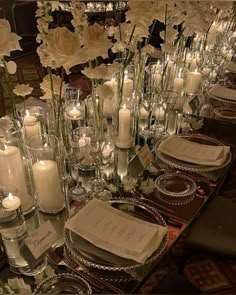 the table is set with candles and plates