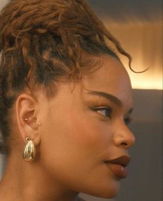 a close up of a person wearing earrings