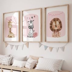 three framed pictures hang on the wall above a wooden bench with pillows and pillow cases