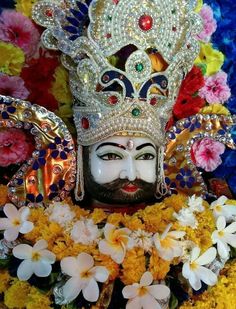 an idol is adorned with flowers and jewels