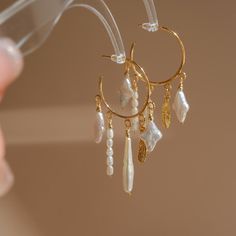 P E A R L ∙ E A R R I N G These beautiful earrings were handmade with love in my studio in Chicago, I designed the "Dreamcatcher" using a variety of uniquely shaped pearls, and each pendant is lovely and unique, blossoming in the ear. * Material: 18K Gold Plated  （Ear pin is partially sterling silver.） * Length: ≈ 2.3" O T H E R ∙ I N F O R M A T I O N * Every order includes elegant, reusable jewelry packaging. Specify in order notes for multiple gift boxes ♡ * If you have any questions or need custom design advice, please feel free to contact us via email; we will respond promptly :) T U R N ∙ A R O U N D ∙ T I M E * Processing Time: 3-7 business days * Delivery Time: 3-10 days worldwide * Free standard shipping. * For precise delivery, please contact us. C A R E ∙ I N S T R U C T I O N S Unique Pearl Jewelry, Baroque Pearls Jewelry, Star Pearl, Unique Hoop Earrings, Ear Pin, Jewelry Girl, Wedding Gifts For Bridesmaids, Design Advice, Earring Crafts