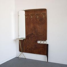 a mirror and coat rack in the corner of a room with no one on it