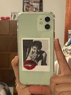 a person holding up a cell phone case with an image of a man and woman on it