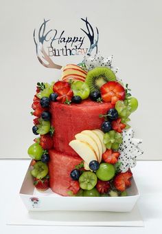 a red cake with fruit and berries on it