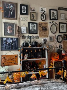 a bedroom decorated for halloween with pumpkins and pictures on the wall, bookshelf