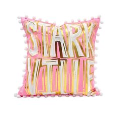 a pink and gold pillow with white pom - poms on the bottom that says start