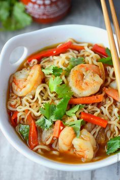 a bowl of shrimp noodle soup with chopsticks