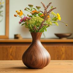 a wooden vase filled with flowers on top of a table