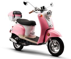 a pink scooter is parked on a white surface