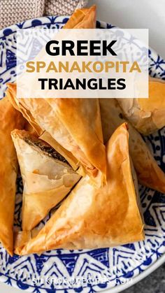 some food on a blue and white plate with the words greek spanacopta triangles